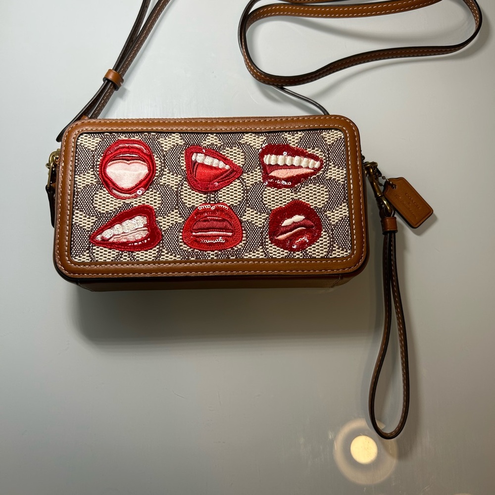 Coach Brown Signature Canvas Crossbody with Red Lip Appliqués